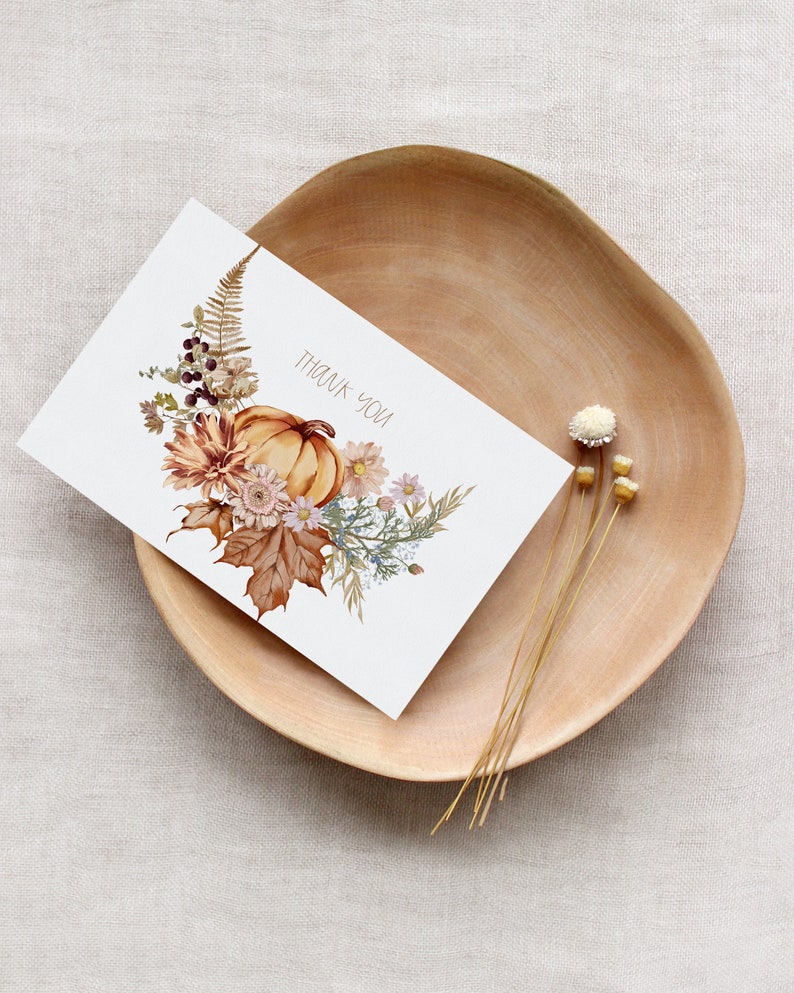 May include: A white card with a watercolor illustration of a pumpkin, leaves, and flowers. The text "Thank You" is printed on the card.