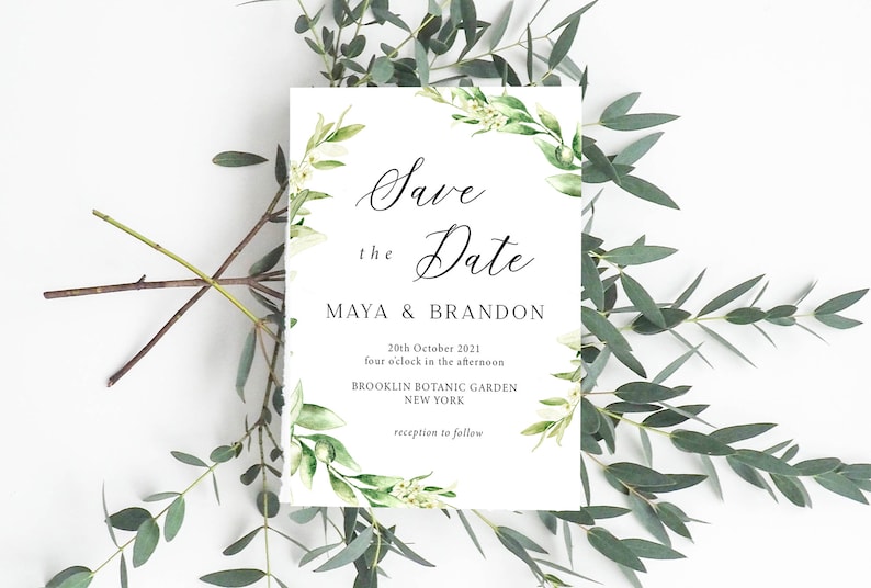 May include: Save the Date card with a green floral wreath border. The text reads "Save the Date, Maya & Brandon, 20th October 2021, four o'clock in the afternoon, Brooklyn Botanic Garden, New York, reception to follow."