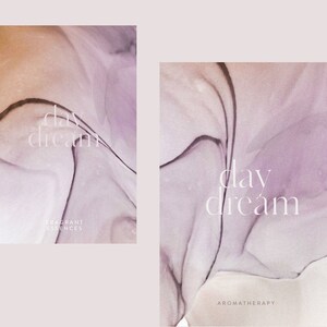 May include: Two abstract art prints with a purple and brown watercolor background. The text "day dream" is written in white on each print. The left print has the text "Fragrant Essences" below the main text. The right print has the text "Aromatherapy" below the main text.