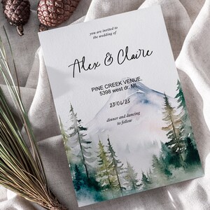 May include: Wedding invitation with a watercolor illustration of a mountain range and pine trees. The text reads "you are invited to the wedding of Alex & Claire, PINE CREEK VENUE, 5398 west dr. Mi, 23/04/25, dinner and dancing to follow."