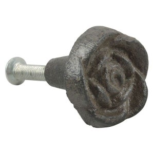 May include: A cast iron cabinet knob with a rose design. The knob is dark gray and has a silver screw.