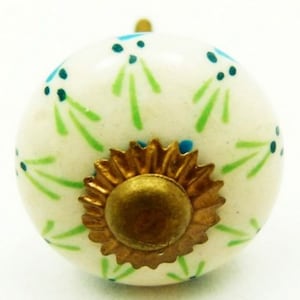 May include: White ceramic knob with a gold metal base. The knob is decorated with a pattern of green and blue stylized flowers.