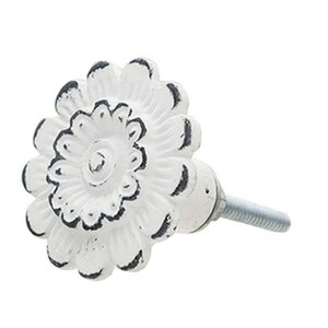 May include: White ceramic flower-shaped cabinet knob with a distressed finish and a silver screw.