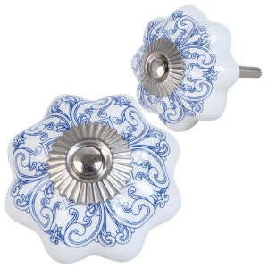 May include: Two white ceramic cabinet knobs with a blue floral design. Each knob has a silver-colored metal base and a screw for installation. The knobs have a scalloped edge and a decorative, ornate pattern.