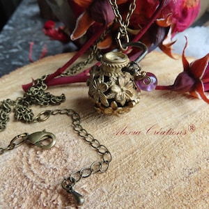 Aromatherapy necklace essential oil diffuser, perfume cage, with lava stone and amethyst.