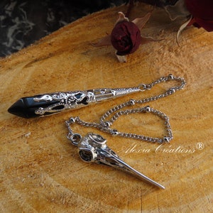 Handmade divination pendulum, crafted by me, with a black obsidian point and silver-plated metal lace.