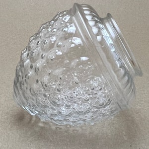 May include: Clear glass lampshade with a textured, bubble-like surface. The shade has a rounded, acorn-like shape with a smooth, slightly raised rim.