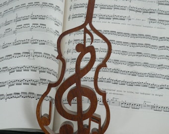 Treble clef in carved wooden cello