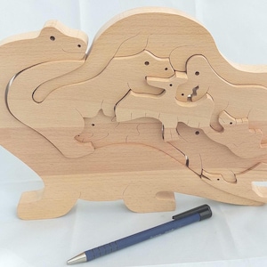 Solid beech wood puzzle cut out, the dinosaur family.
