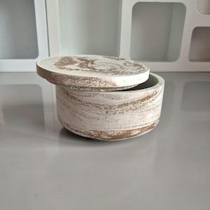 May include: A white ceramic mug with a black handle and the text "But First, Coffee" in a bold, black font. The mug is likely 325 ml in size, ideal for a morning beverage.