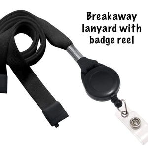 May include: Black breakaway lanyard with badge reel. The lanyard is made of a woven fabric and features a black badge reel and a clear plastic badge holder. The text "Breakaway lanyard with badge reel" is visible.