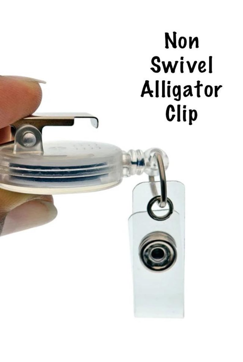 May include: A clear, non-swivel alligator clip badge reel with a metal clip and a clear plastic snap-on holder. The text "Non Swivel Alligator Clip" is printed in black.