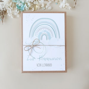 May include: A card with a watercolor rainbow design and the text "Zur Kommunion von Lennard".