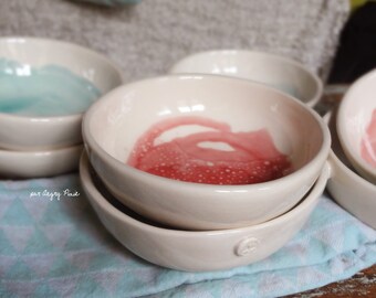 white earthenware bowl with raspberry pink or celadon blue stain