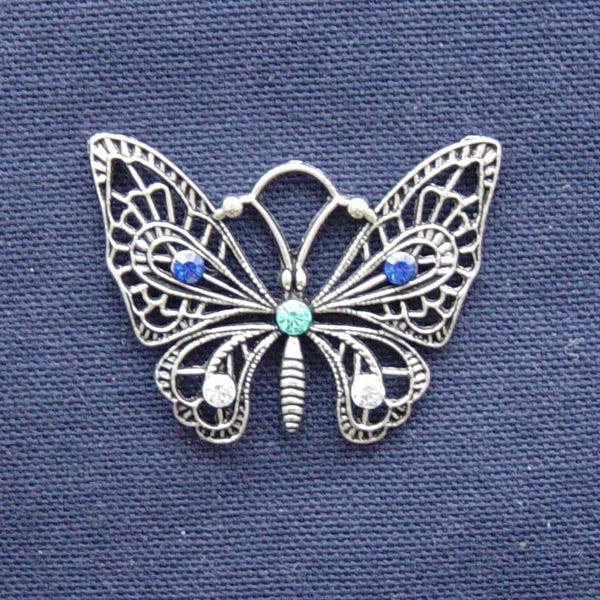 Breloque Papillon en métal argenté strass bleu/turquoise/argent