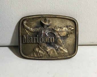 Vintage Marlboro Man Roping Cowboy Solid Brass Belt Buckle. 1975 Signed Bob Seaner Brass Belt Buckle Numbered. Phillip Morris Inc. Promo