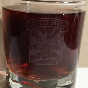 May include: A set of three ceramic mugs with a speckled, matte finish. The mugs are in shades of cream, light gray, and dark gray. Each mug has a simple, minimalist design and a rounded handle.