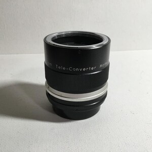 May include: A black and silver teleconverter lens with the text "Tele-Converter Model" printed on the side.