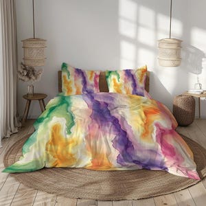 May include: A colourful duvet cover with a watercolour-like design featuring shades of green, yellow, orange, purple, and pink. The duvet cover is made of soft, breathable fabric and is perfect for adding a touch of colour to any bedroom.