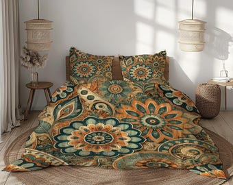 May include: A bed set featuring a floral pattern in shades of teal, orange, and beige. The design includes large, stylized flowers and paisley elements. The set includes a duvet cover and two pillowcases, all with the same pattern.