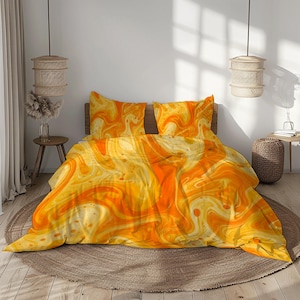 May include: A bed featuring an orange and yellow abstract patterned duvet cover and pillowcases. The bedding is set on a wooden frame, with a circular rug beneath. The design has a swirling effect.