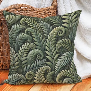 May include: A green throw pillow with a fern pattern. The pillow is made of a soft, plush fabric and has a zipper closure.