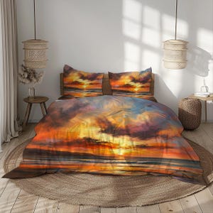 May include: Bedding set with a sunset design. The duvet cover and two pillowcases show a colourful sky in orange, yellow, and purple hues. The bedding is on a bed with a round, woven rug.