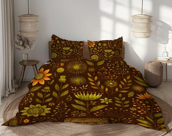 May include: A bedding set featuring a dark brown background with a repeating pattern of stylized flowers, leaves, and stems in shades of yellow, orange, and olive green. The set includes a duvet cover and two matching rectangular pillow shams.