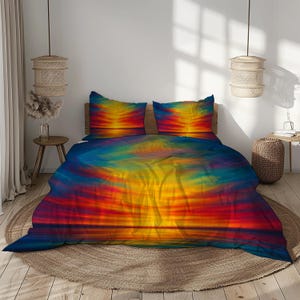 May include: A bed set featuring a vibrant sunset design. The bedding includes a duvet cover and two pillowcases, showcasing a blend of red, orange, yellow, and blue hues. The design evokes a sense of warmth and tranquility, perfect for a bedroom.
