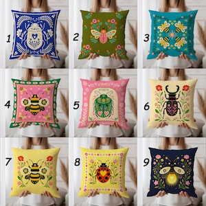May include: Nine decorative throw pillows with insect and floral designs. Pillows feature various colors, including blue, green, pink, and yellow. Designs include beetles, bees, and a ladybug. Each pillow has a unique pattern, perfect for home decor.