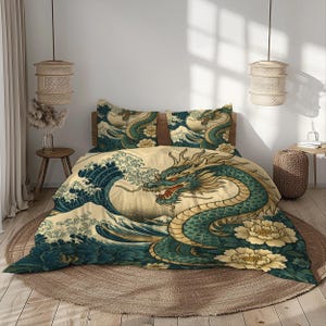 May include: A beige duvet cover and two pillowcases feature a teal dragon design with red accents, set against a backdrop of ocean waves and cream-colored flowers. The bedding set is placed on a round, woven rug.