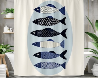 May include: A white shower curtain with a blue circle in the center. Inside the circle are five stylized blue and white fish. The fish are arranged vertically, with the largest fish at the top and the smallest fish at the bottom.