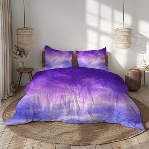 May include: A bed with a purple and blue abstract pattern bedding set. The set includes a duvet cover and two pillowcases. The bedding has a watercolor effect with shades of purple, blue, and white. The bed is on a round, woven rug.