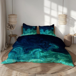 May include: A bedding set featuring a duvet cover and two pillowcases. The design showcases a swirling pattern in shades of teal and navy blue, creating a fluid, abstract effect. The bed is set on a round, woven rug.