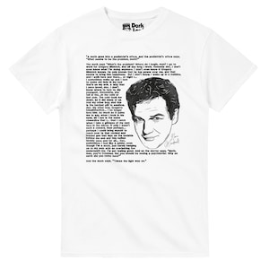 May include: White t-shirt featuring a black and white illustration of a man's face and a quote. The text includes the phrase "Cause the light was on." The shirt has a crew neck and short sleeves.