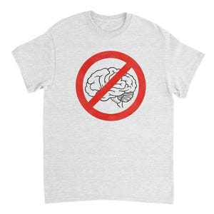 May include: A light gray t-shirt featuring a red circle with a line through it, encompassing a black and white illustration of a brain. The t-shirt has a crew neck and short sleeves.