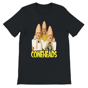 May include: A black short-sleeve t-shirt featuring a graphic print of three characters with tall, pointed cone-shaped heads. The characters wear white collars and yellow accents. The word CONEHEADS is printed in large yellow letters below the image.