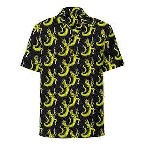 May include: Black button-up shirt with a repeating pattern of yellow cartoon creatures. The short-sleeved shirt has a classic collar and is made of a lightweight fabric. The design features a unique and eye-catching print.