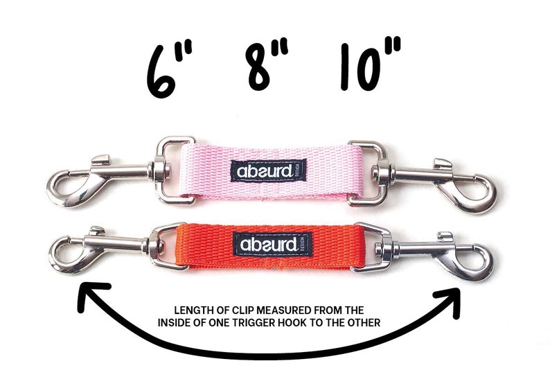 May include: Two dog leashes with silver trigger clips and a pink and orange strap. The leashes are labeled "abaurd" and measure 6 inches, 8 inches, and 10 inches. The text "LENGTH OF CLIP MEASURED FROM THE INSIDE OF ONE TRIGGER HOOK TO THE OTHER" is written below the leashes.