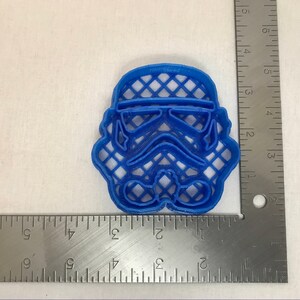 May include: Blue plastic cookie cutter shaped like a Star Wars Stormtrooper helmet.