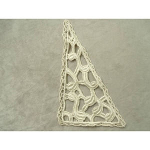 May include: A white lace trim with a triangular shape and a delicate floral pattern.