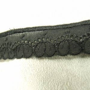 May include: Black lace trim with a scalloped edge.