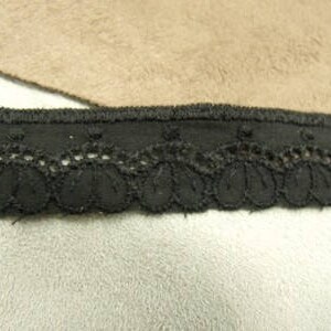 May include: Black lace trim with scalloped edges and a solid black band.