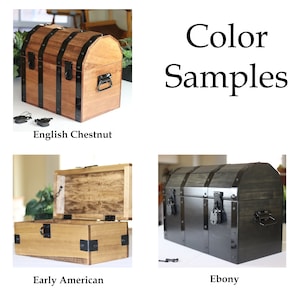 May include: Color samples of a wooden treasure chest in English Chestnut, Early American, and Ebony finishes. The chests have black metal accents and hardware.