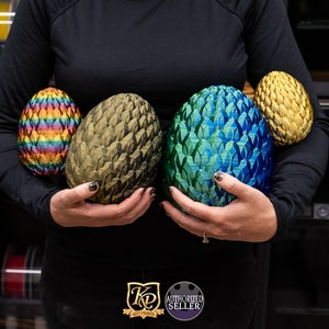 May include: Four dragon eggs, one with a rainbow pattern, one with a green and blue pattern, one with a gold pattern, and one with a dark green pattern.