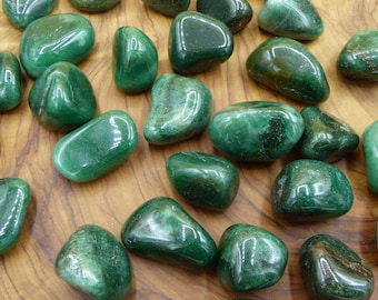 May include: A collection of smooth, green aventurine tumbled stones. The stones are various sizes and shapes, with a glossy finish.