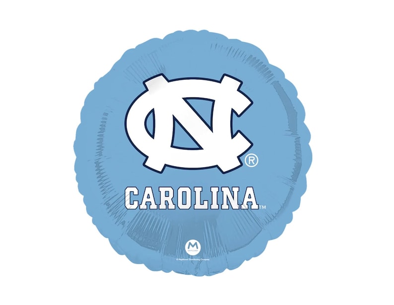 May include: A light blue round balloon featuring the University of North Carolina logo in white. The word "CAROLINA" is printed in white below the logo. The balloon has a metallic finish.