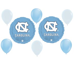 May include: A collection of light blue and white balloons, including two round foil balloons. The foil balloons feature the word "CAROLINA" and a white logo on a light blue background. The other balloons are solid light blue and white.
