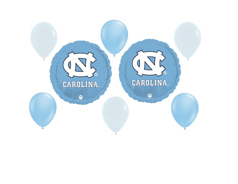 May include: A collection of light blue and white balloons, including two round foil balloons. The foil balloons feature the word "CAROLINA" and a white logo on a light blue background. The other balloons are solid light blue and white.