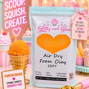 May include: A light blue pouch of Glittz and Glue Air Dry Foam Clay in pumpkin orange. The packaging features a heart-shaped window, text reading "SCOOP. SQUISH. CREATE.", and a net weight of 17.6 ounces. A tag reads "SO SOFT. SO FLUFFY. SO FUN TO CREATE!"